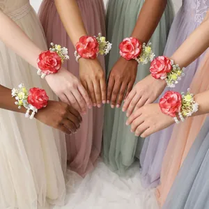 Red rose bridesmaid wrist corsages with pearl bracelets shown on diverse models in gowns