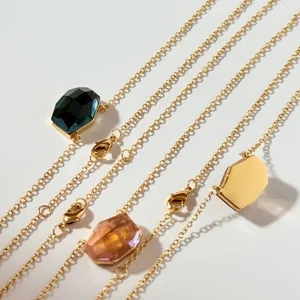 Detailed macro view of gold link necklaces with assorted irregular faceted stones