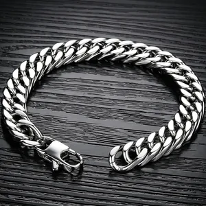 Macro detail of polished silver double-woven Cuban link bracelet with lobster clasp