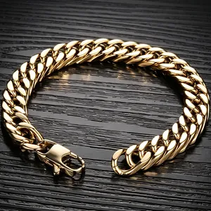 Detailed close-up view of a double woven gold-toned Cuban link bracelet on dark wood