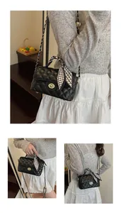 Detail views of black quilted crossbody bag with chain strap and decorative scarf