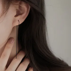 Minimalist long black chain ear line earring for women shown in a close-up lifestyle shot
