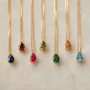 Elegant minimalist gold chain necklace featuring a variety of colorful teardrop gemstone pendants