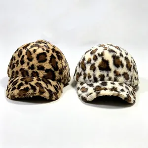 Detailed close-up showing two leopard print faux fur plush baseball caps in different colors