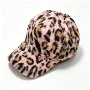 Close-up detail of a pink leopard print plush baseball cap with fuzzy texture.