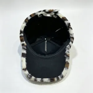 Detail view of winter leopard print plush baseball cap with warm black inner lining