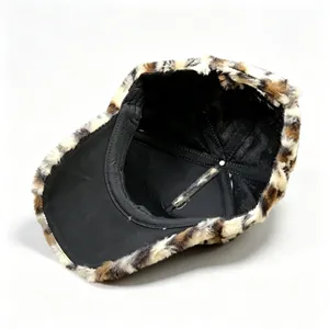 Close-up detail showing the thick inner lining of a warm leopard print plush baseball cap.