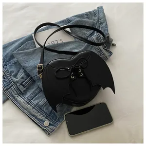 Detailed view of black bat wing heart-shaped crossbody bag with lace-up design