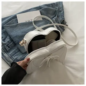 Detailed interior view of white heart-shaped bat wing crossbody bag for Halloween.