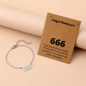 Detail view of a silver stainless steel 666 angel number bracelet with a kraft card