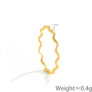 Detail view of a minimalist gold wavy stainless steel ring featuring 1mm thickness and 0.4g weight