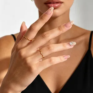 Minimalist stainless steel gold wave ring for women worn on fingers for a chic look