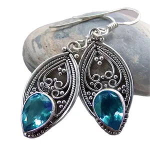 Vintage teardrop earrings with sea blue crystal and silver filigree patterns