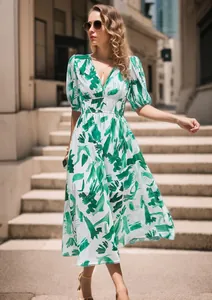 Model wearing a green floral V-neck maxi dress on outdoor stairs, showing fabric flow.