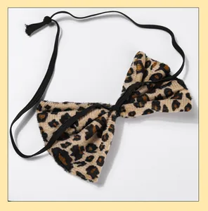 Close-up detail of leopard print plush texture and elastic strap on costume bow tie.