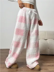 Detailed view of pink and white checkered plush high-waisted wide-leg warm pants
