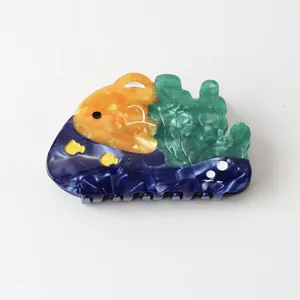 Detailed view of handmade acetate goldfish hair claw clip with marbled texture