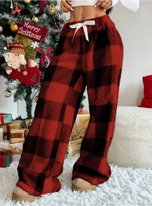 Close-up of cozy red and black buffalo plaid fleece pants with white drawstring detail