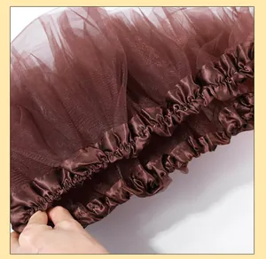 Close-up of brown ruffled satin and layered tulle fabric detail for costume