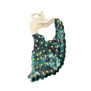 Unique peacock-shaped acetate hair claw clip with emerald green and cream dancer design