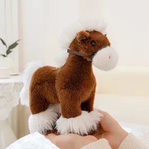 Close-up detail of a soft brown and white plush pony toy held in hands for a cozy feeling.