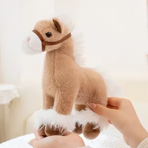 Close-up of a soft light brown plush horse toy with white mane being held in hands