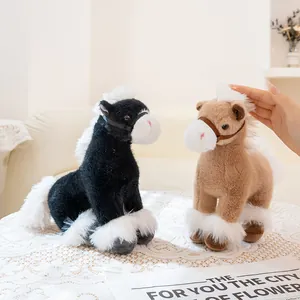 Detailed view of black and tan plush horse toys on a lace tablecloth