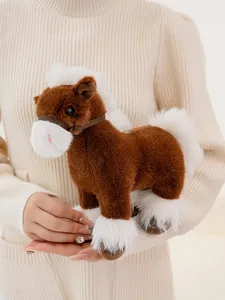 Detailed view of a soft brown and white plush horse toy held by a person showing texture