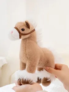 Close-up of a soft and realistic brown horse plush toy being held by human hands