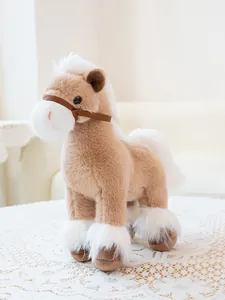 Side view detail of a soft brown and white plush horse toy on a lace tablecloth