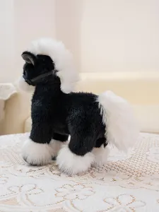 Rear macro view of black and white plush horse toy with fluffy mane and tail