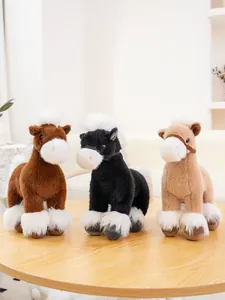 Soft plush horse toys in brown black and tan with fluffy white manes on table