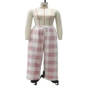 Detail view of soft pink and white plaid fleece lounge pants on a mannequin.