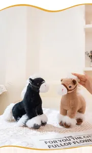 Detailed view of soft black and brown plush horse toys with fluffy white manes on a table.