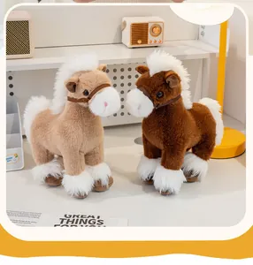 Close-up of two cute brown and tan plush horse toys with fluffy manes on a desk