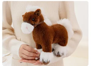Realistic brown and white plush horse toy held in hands, close-up soft texture detail.