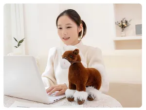 Soft realistic brown horse plush toy mascot presented on a desk next to a white laptop