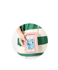 Close-up of a pink mini crossbody phone bag featuring a transparent touch window