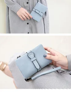 Macro detail of a light blue PU leather foldable wallet showing fine stitching and strap buckle