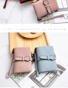 Lifestyle detail of minimalist PU leather foldable short wallets in pink and light blue