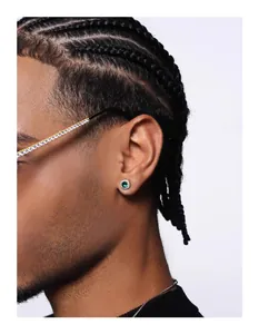 Close-up detail of a hip hop style square green gemstone stud earring with a halo setting