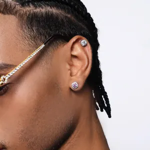 Silver iced out hip-hop stud earrings with pink stone and white crystals on male model
