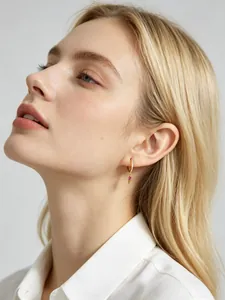Exquisite close-up of gold S925 silver hoop earring with red marquise stone on model