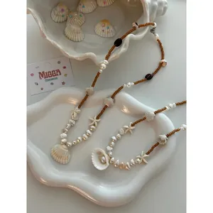 Detailed macro view of handmade shell and pearl beaded necklace for summer beach vacation style