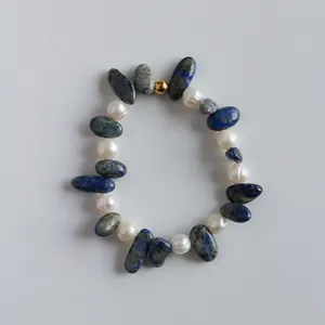 Detailed close-up showing natural blue lapis lazuli stones and white baroque pearls
