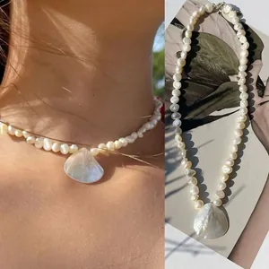 Elegant natural pearl beaded necklace with a white shell pendant for beach style