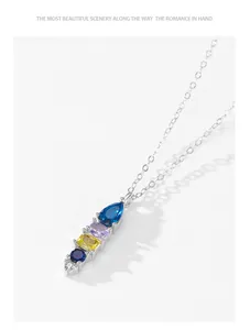 Close-up detail of geometric colorful gemstone pendant on a 925 silver chain necklace.