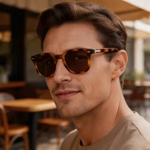 Close-up of model wearing vintage tortoiseshell square sunglasses outdoors