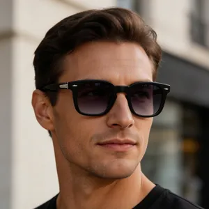 Close-up of classic retro square black sunglasses with gradient lenses on male model.