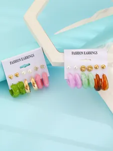 Colorful resin hoop and stud earring sets featuring 6 pairs per card on display